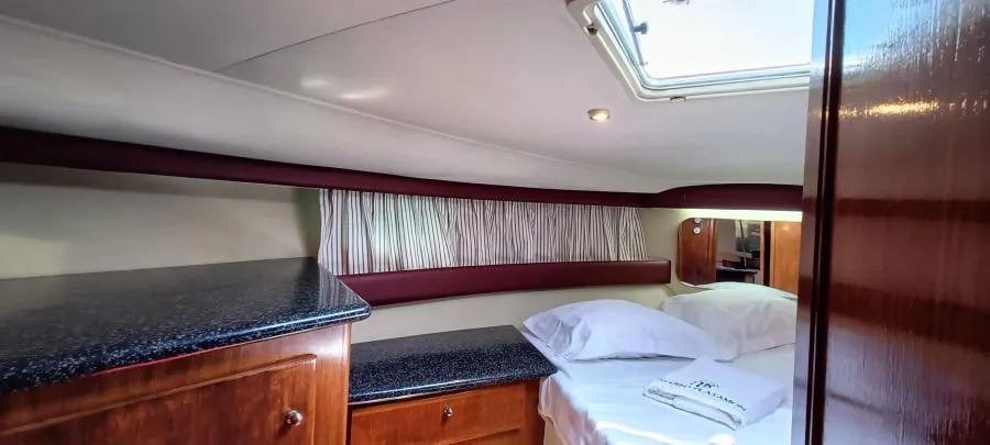 A double bed below the cabin's overhead hatch